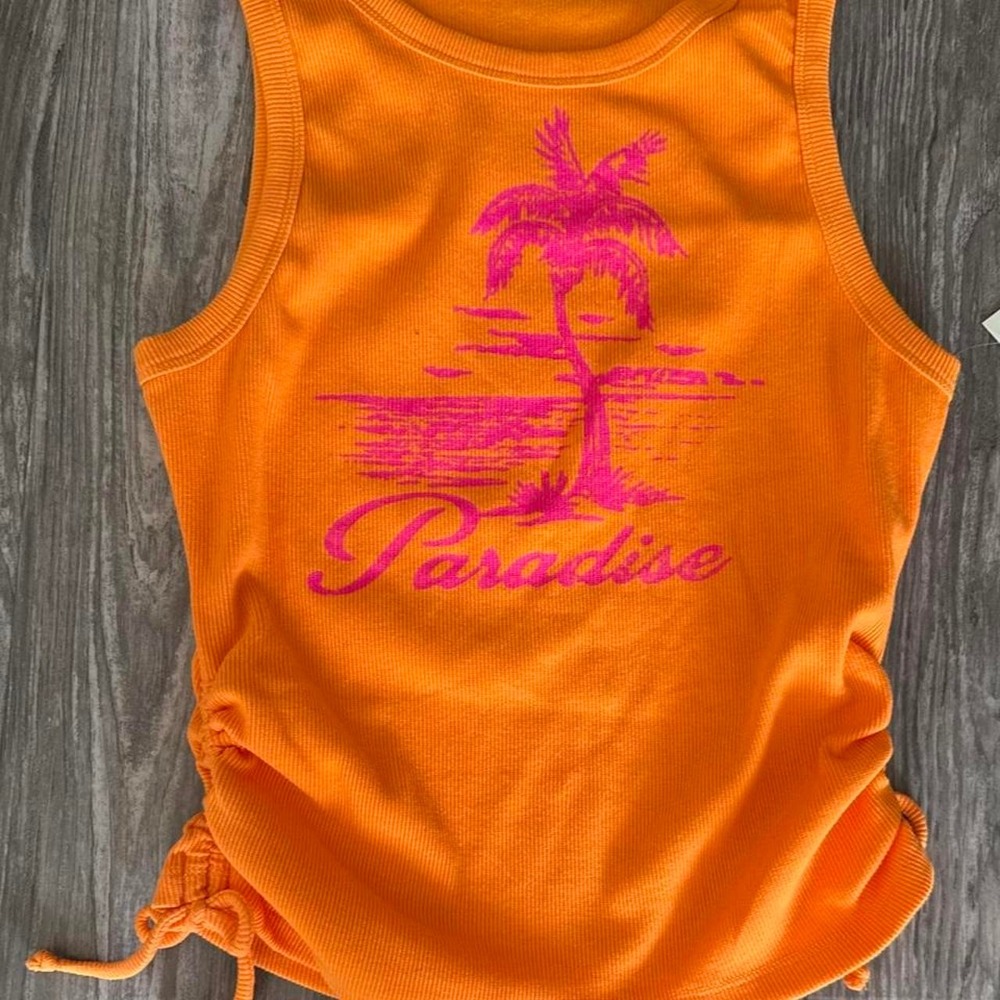 Orange tank top with pink palm tree and 'Paradise' graphic